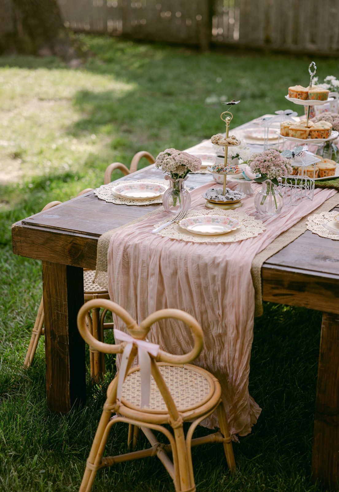 Garden party table detail with florals and child-sized chairs styled for a celebration