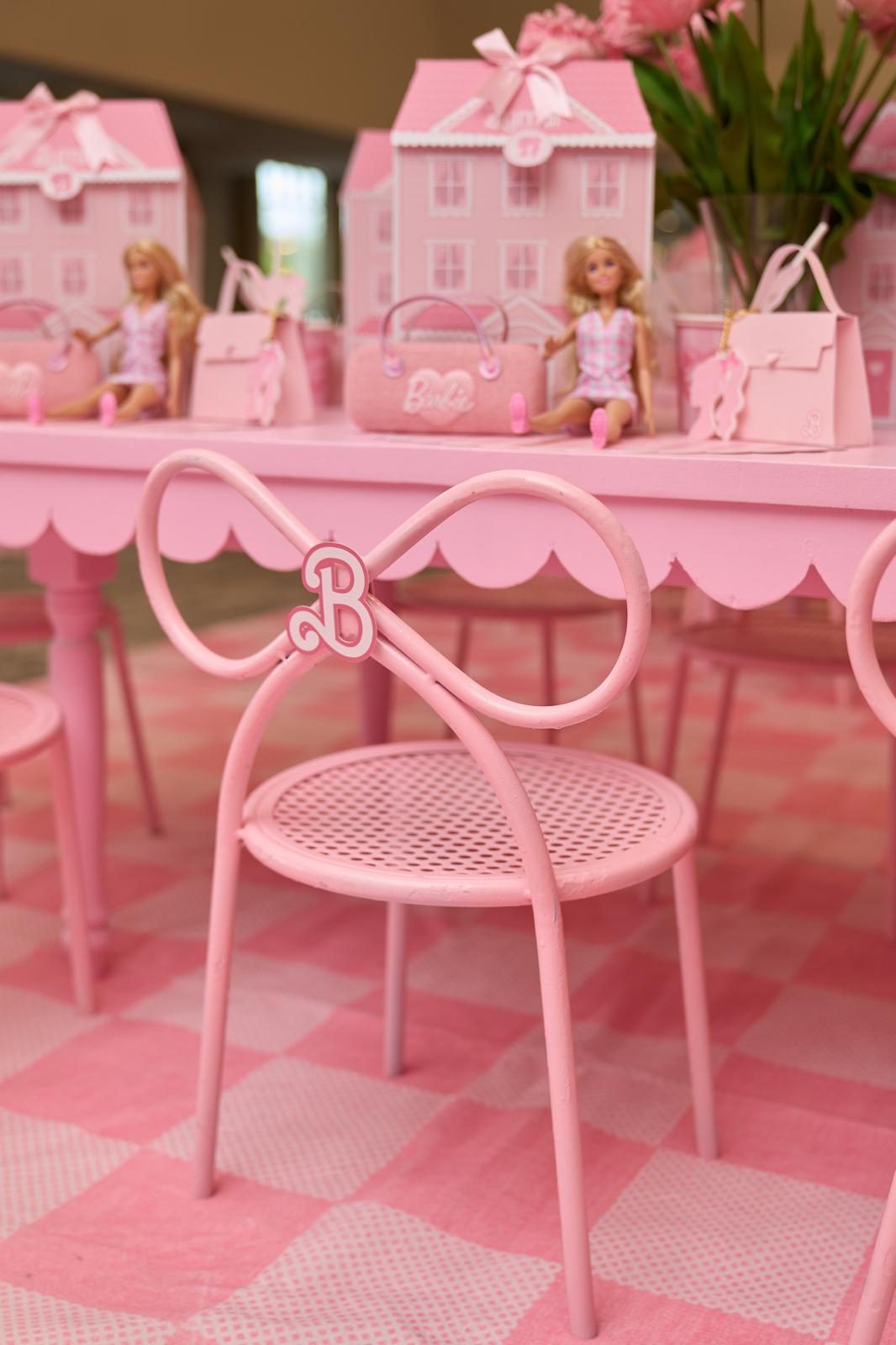 Close-up of a pink bow-back children's rental chair